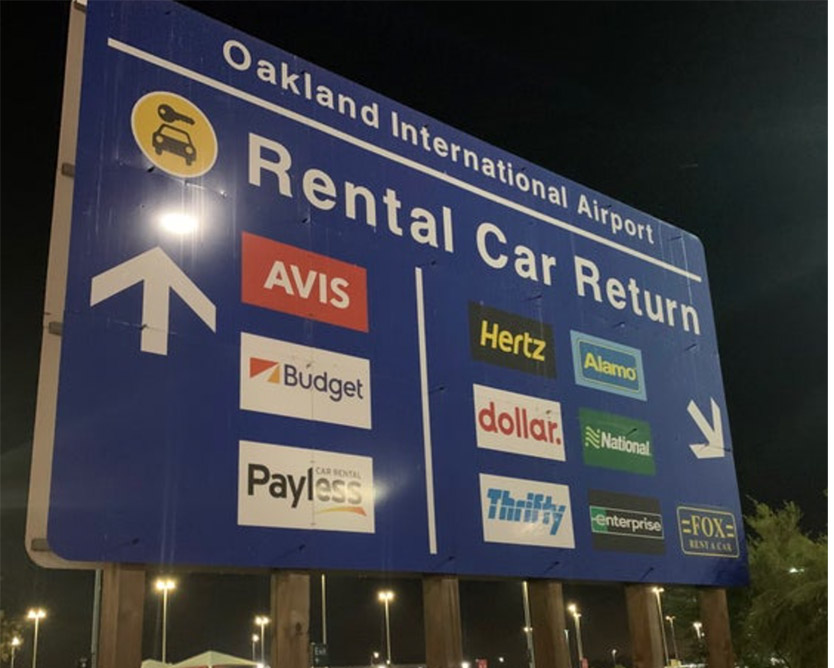 The sign at Oakland International Airport shows that Avis/Budget rental cars are returned to a different area than the Hertz/Thrifty vehicles.  