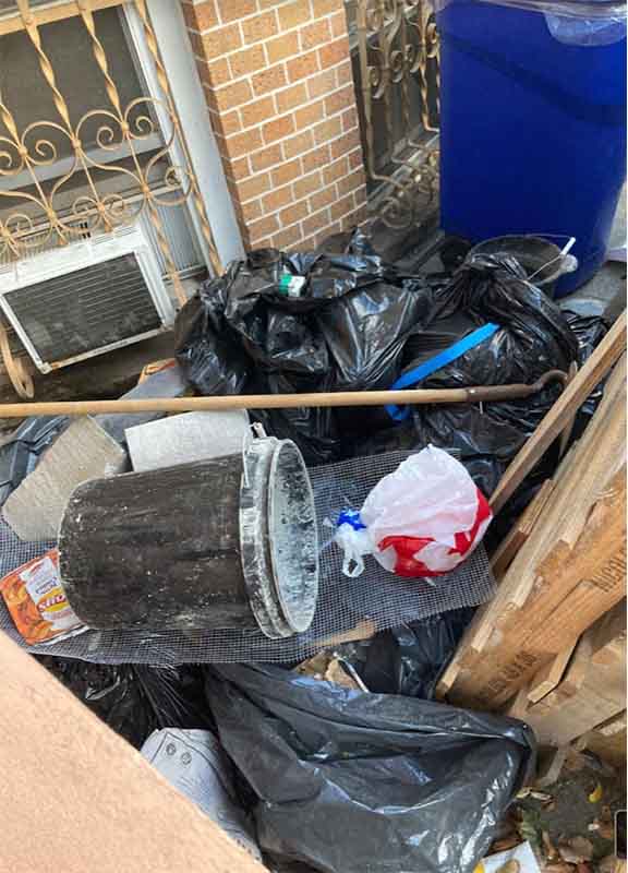 Garbage is piled up high outside this New York City area Vrbo rental. 