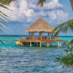 The Maldives, blue ocean, blue sky, tropical trees.