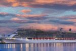 Celebrity Cruises denied boarding pregnant passenger, Celebrity Reflection, cruise ship on the ocean, Cruise ship at sunset.
