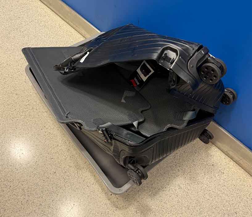 Destroyed luggage Destroyed luggage, missing belongings, smashed bag, aircraft ran over luggage