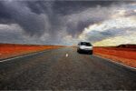 Car rental company banned customer, rental car along a road with a storm above
